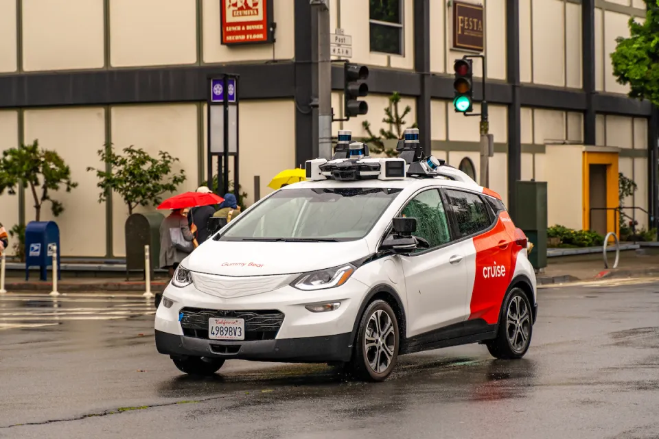 White and red Cruise autonomous car on San Francisco street.